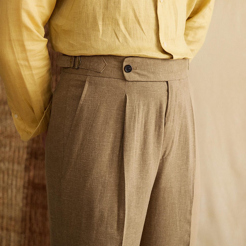 Pleated cuffed trousers with high-rise waistband and tailored structure