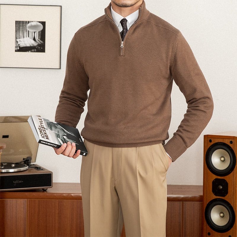 Quarter-zip wool pullover sweater paired with dress pants and a tie indoors