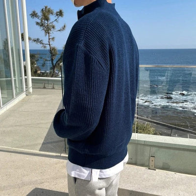 Ribbed knit zip-up pullover with high collar and front half-zip design