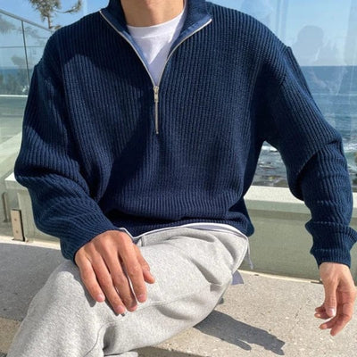 Ribbed knit zip-up pullover with high collar and front half-zip design