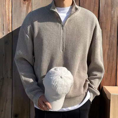 Ribbed knit zip-up pullover with high collar and front half-zip design