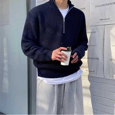 Ribbed knit zip-up pullover with high collar and front half-zip design